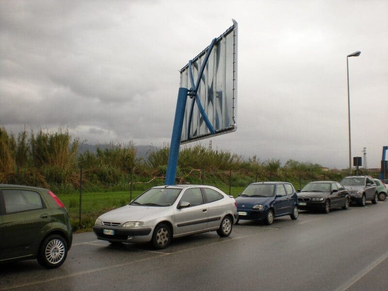 Cars parked under billboard