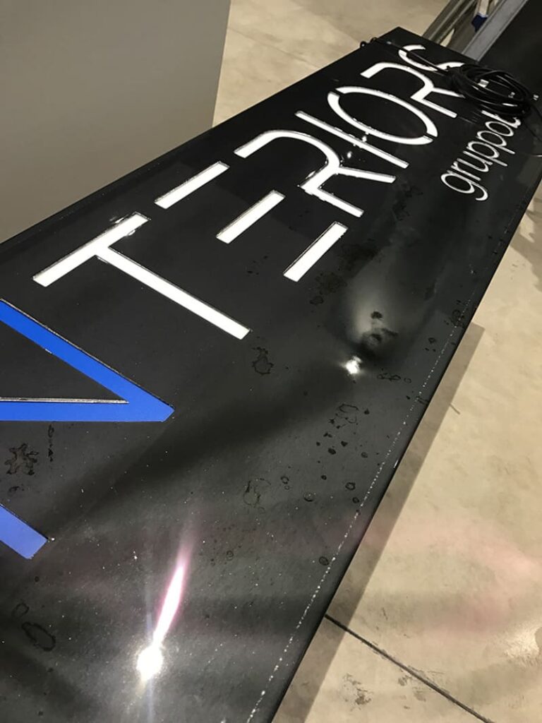 Damaged black signboard